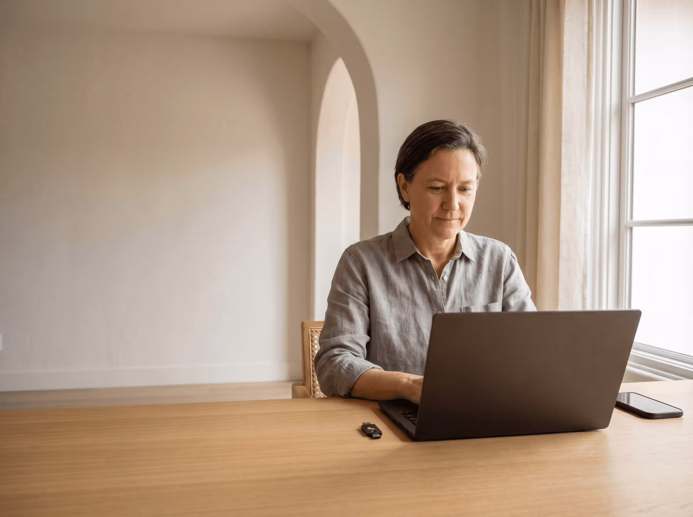 Calm home workspace with laptop — digital certificate and secure admin for property owners in Spain