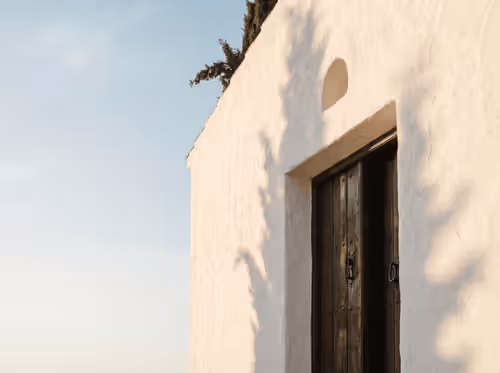 Whitewashed Spanish facade and door — property registry clarity for owners in Spain